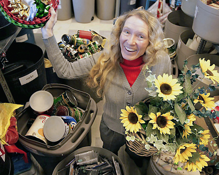 Women in Reuse Centre surrounded by reusable items.