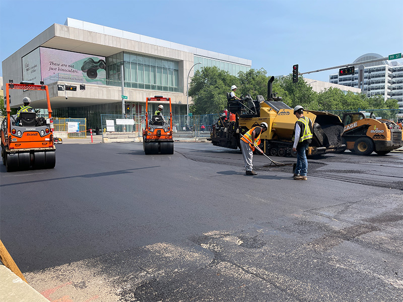 Paving crews paving roadway on 103A Ave and 99 Street