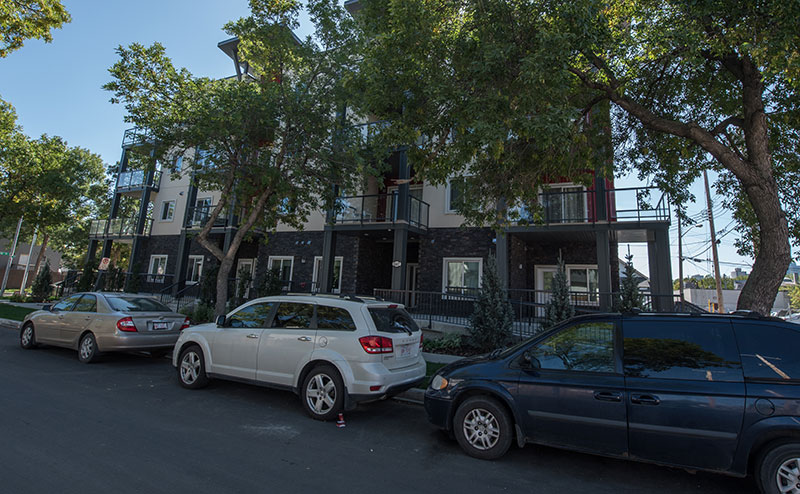 cars parked on-street in front of infill houses