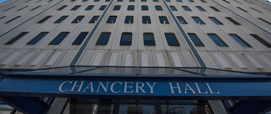 An upwards angled view of the signage above the front entrance of Chancery Hall building in Edmonton.