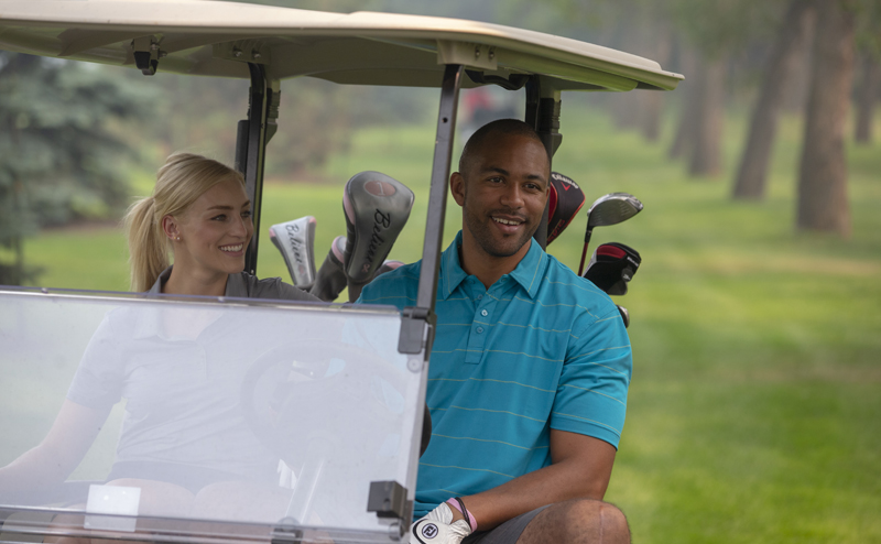 People in a powered golf cart