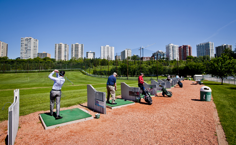 People swinging clubs at Victoria driving range.