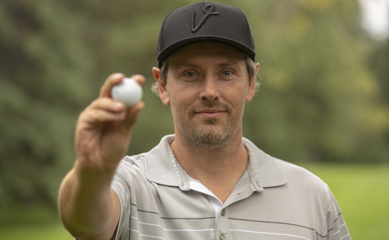 Person holding up a golf ball