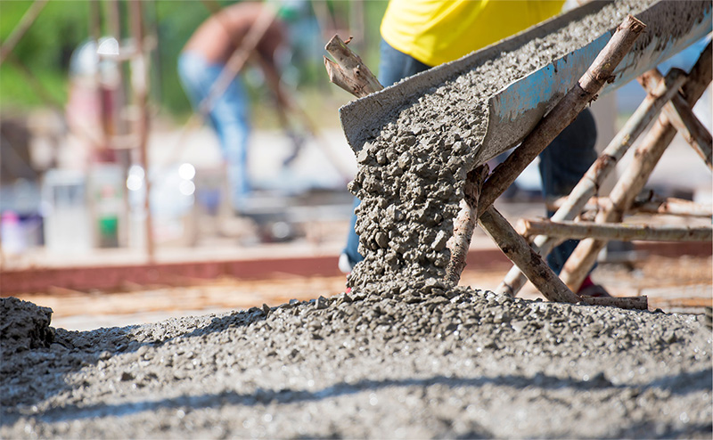 Cement being poured from a metal trough
