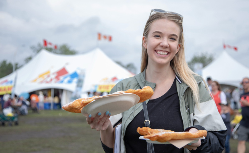 Girl with food at Heritage Festival in Hawrelak Park