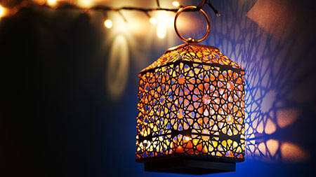 lantern hanging at night in front of blue decorative background