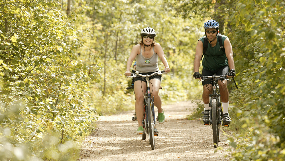 Cyclist riding on a river valley trail