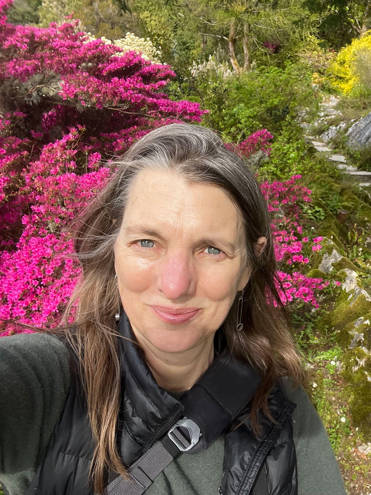 person standing in front of flower trees