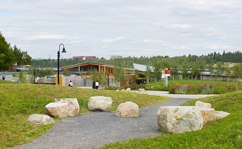 grassy pathway lined with large boulders