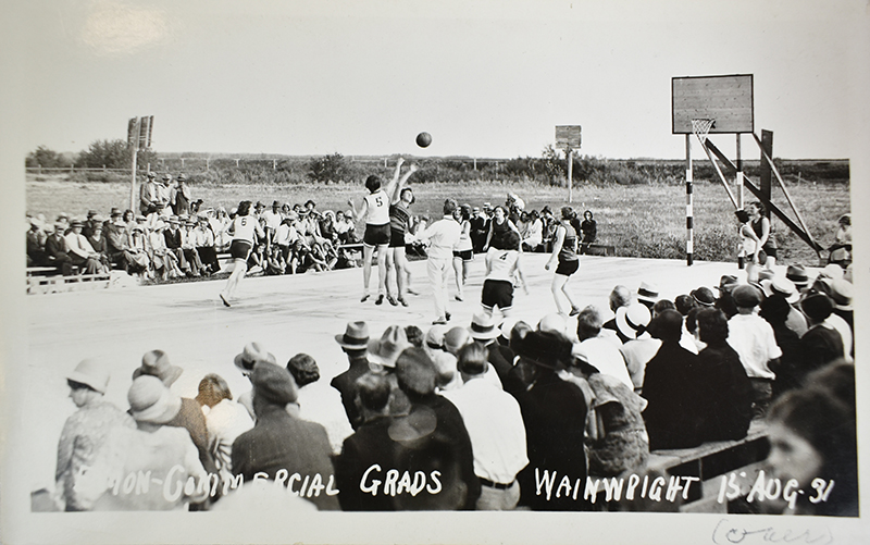 Black and white postcard of Grads playing Gradettes in an exhibition game in Wainwright, 1931