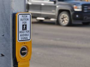 sign that says Push button for hold for audible signal