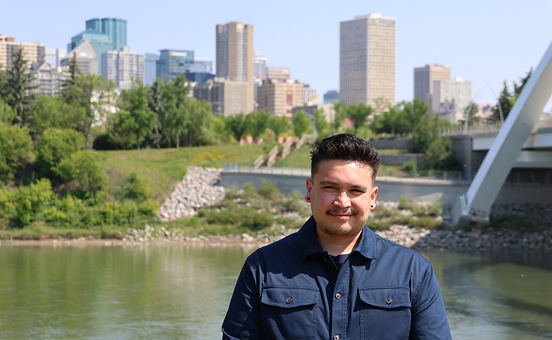 indigenous persons standing in front of nature backdrop or North Saskatchewan River