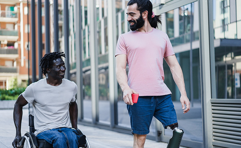 person of diverse abilities using crayon with attendant