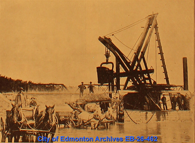 A large gravel dredger: a tall pully system in water.