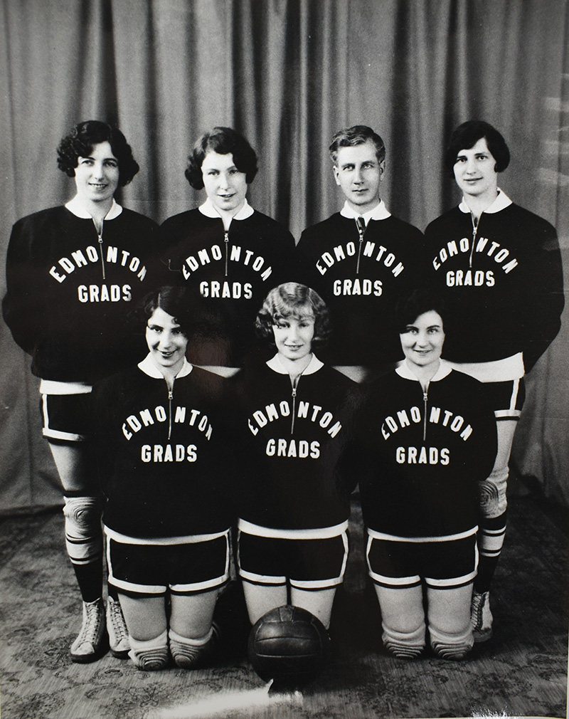 Black and white team photo of the Edmonton Grads and Coach Percy Page.