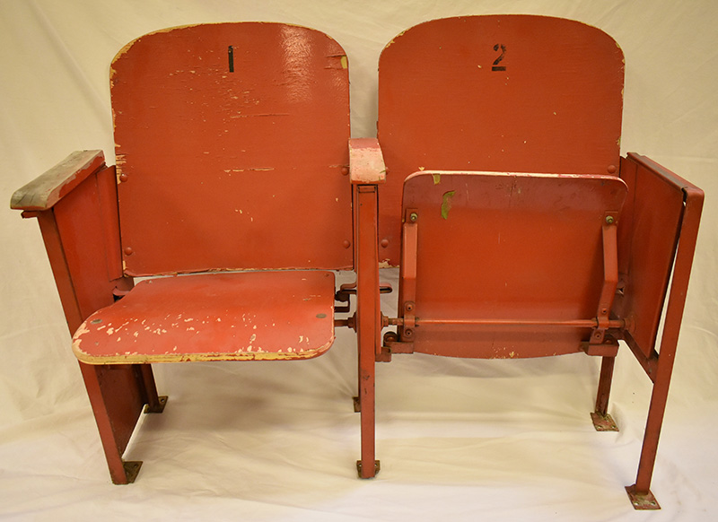 Two red wooden arena seats