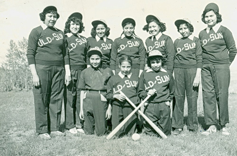 Black and white photo of the girls' softball team at Old Sun Residential School in the 1940s.