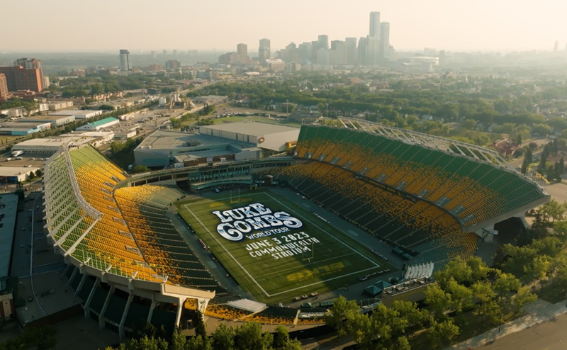Overhead photo of Commonwealth Stadium. The following text is displayed in the middle of the stadium field: Luke Combs World Tour. June 3 2023. Commonwealth Stadium.