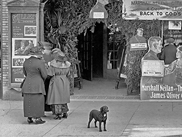 The entrance to a theatre, with movie showings advertised in front of it.