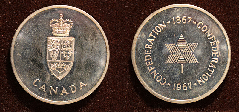 The front and back of a gold coloured medallion. One side features the Canadian Coat of arms, and the inverse features the Centennial maple leaf symbol.
