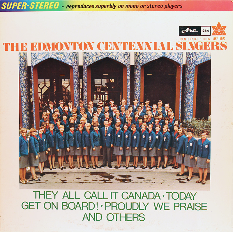 A group photo of a choir, dressed in a matching blue uniform suit jacket.