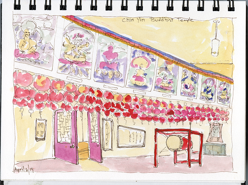 A sketch of the interior of a Buddhist temple with yellow walls and red lanterns and decor.