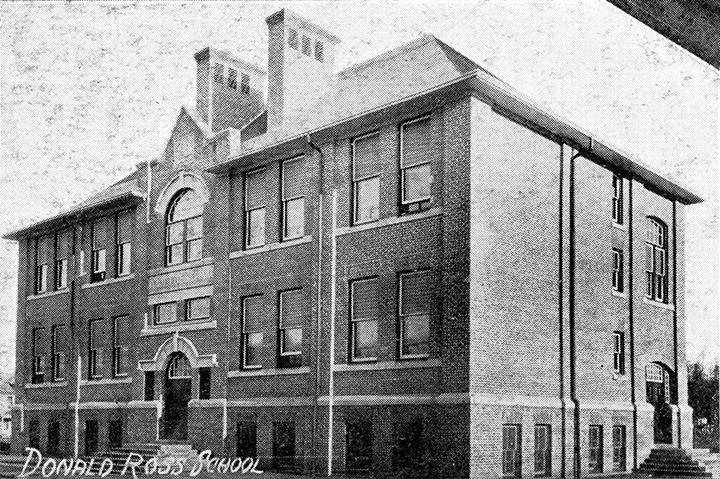 Black and white photo. A large multi-story school building. A front and side entrance is visible, each with a set of stairs leading up to it. Text overlaid in the bottom-left corner reads "Donald Ross School".