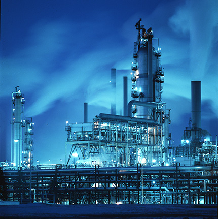 A refinery at night with blue lights, giving the entire photograph a rich blue colour.