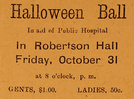 An orange poster with black text advertising a Halloween Ball.