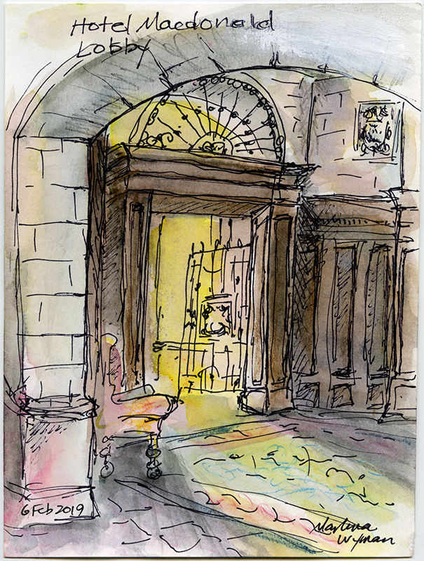 A drawing of the lobby of Hotel Macdonald: a stone archway before a large wooden doorway that is illuminating yellow light.
