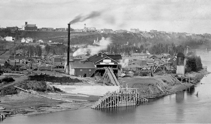 A black and white photo of Edmonton in the early 1900s, showcasing industrial plants and the Edmonton Incline Railway.