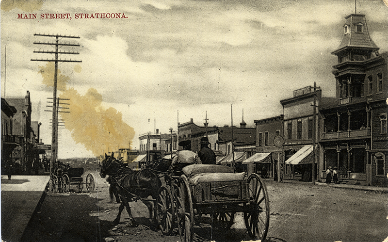 Ablack and white photo of Main Street in 1900, with a horse pulling a carriage in the foreground.