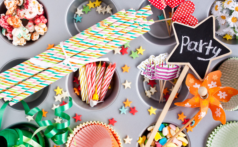 Snacks and party favours spread out on a table. The word "Party" is written across a star-shaped decoration.