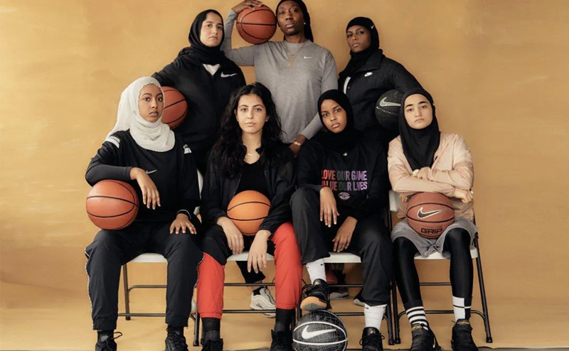 Muslim female basketball players pose for a photo.