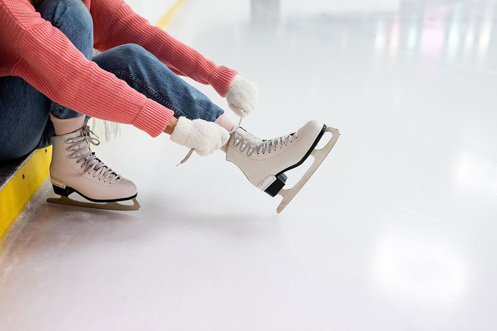 skater putting on ice skates