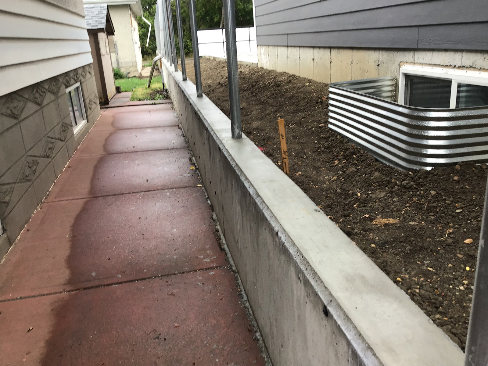 Concrete retaining wall and a proposed new fence