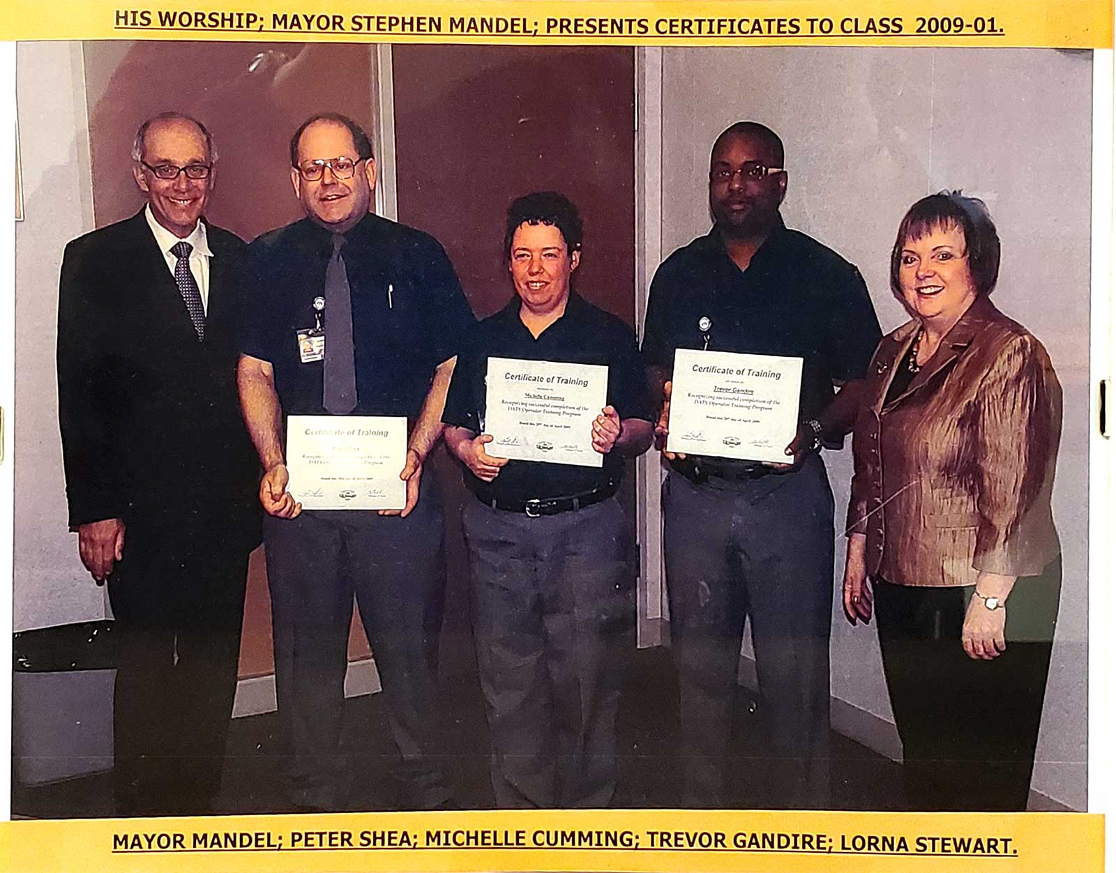 (L to R) Former Mayor Steven Mandel presents the DATS graduating class of 2009 their certificates. From the left, Peter Shea, Michelle Cumming, Trevor Gandire and Lorna Stewart