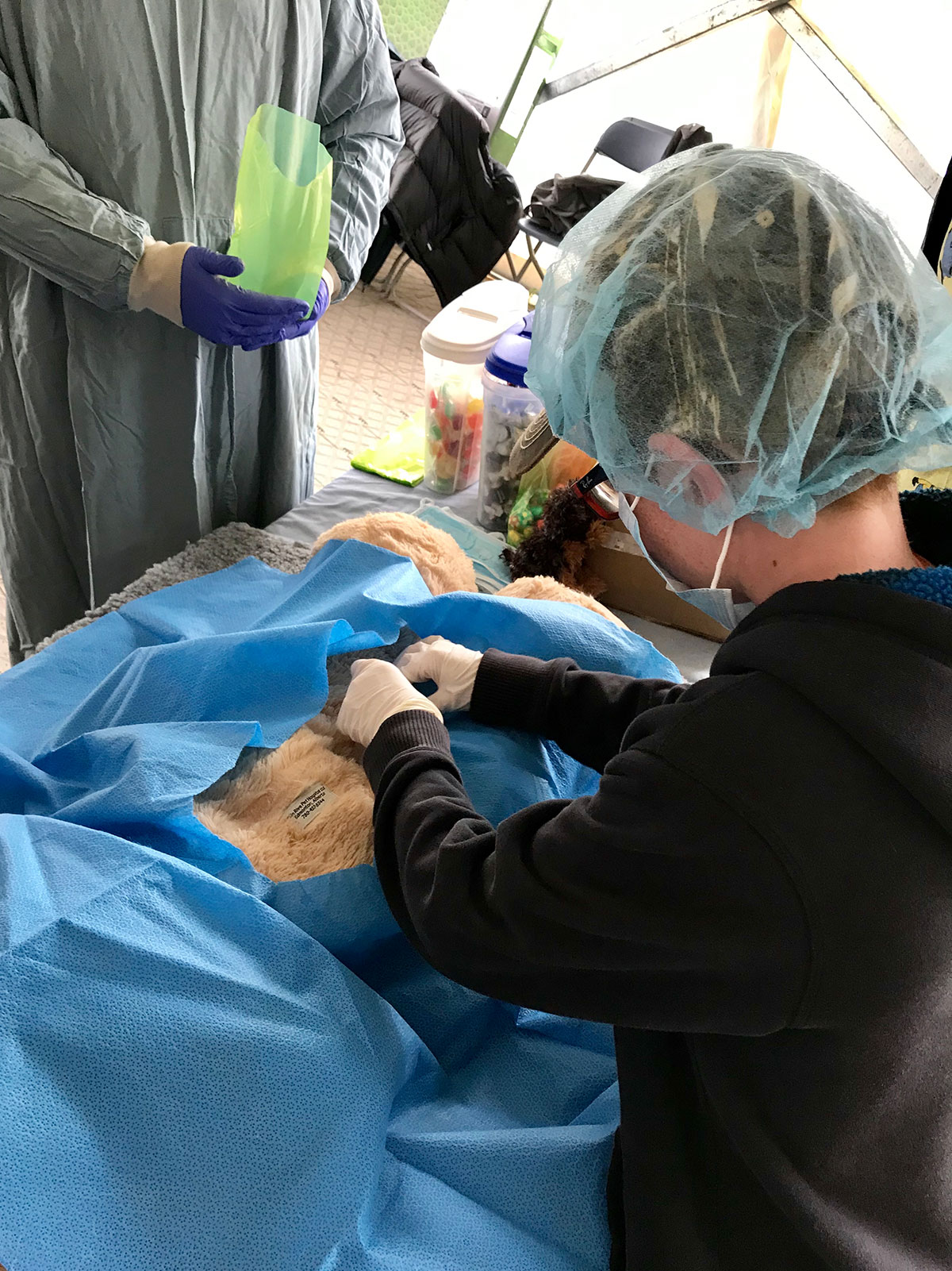 Kid 'veterinarians' operating on their 'animals'