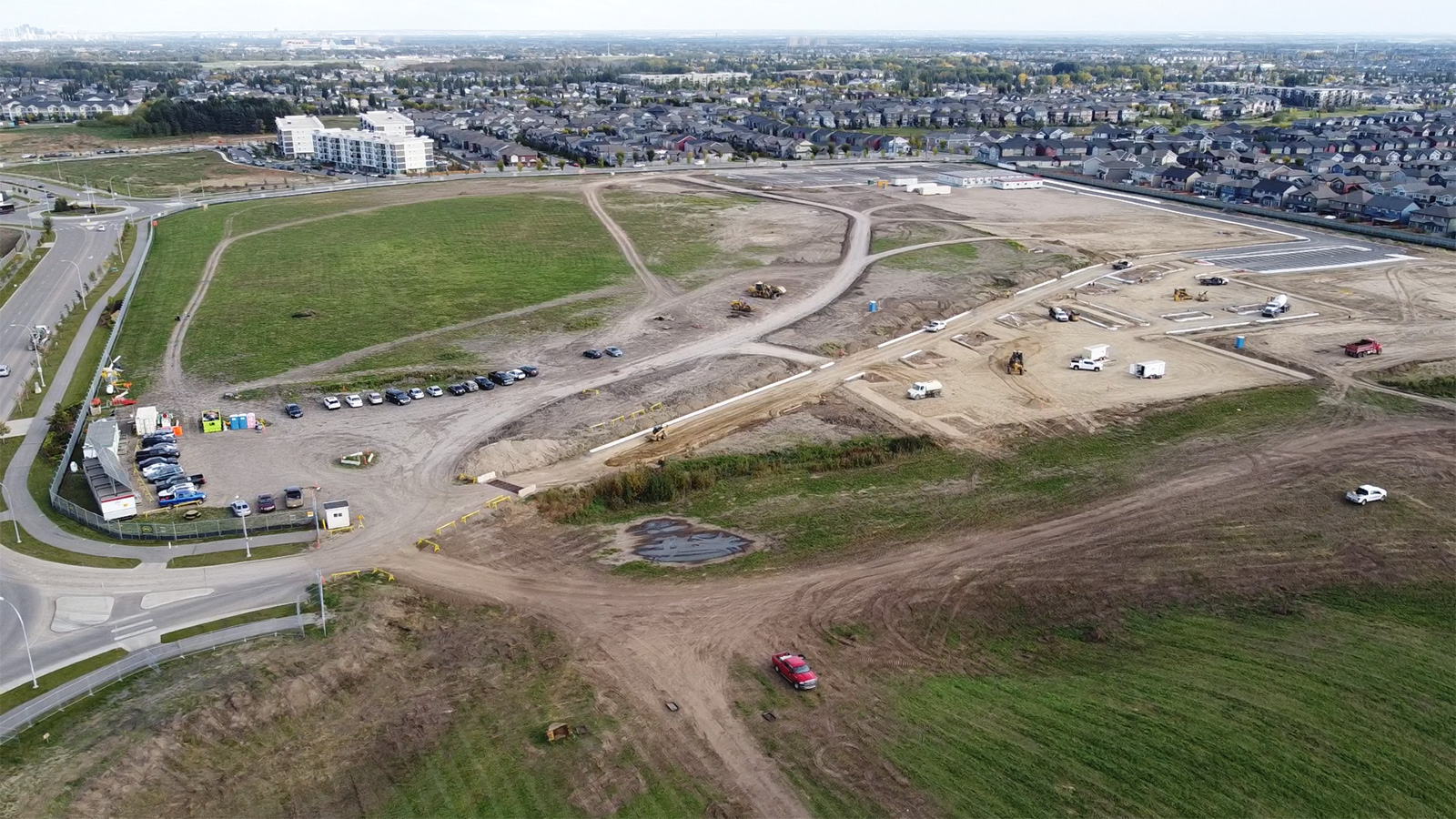 Northwest view of the site showing casing, the trailer complex setups and the ongoing parking lot development