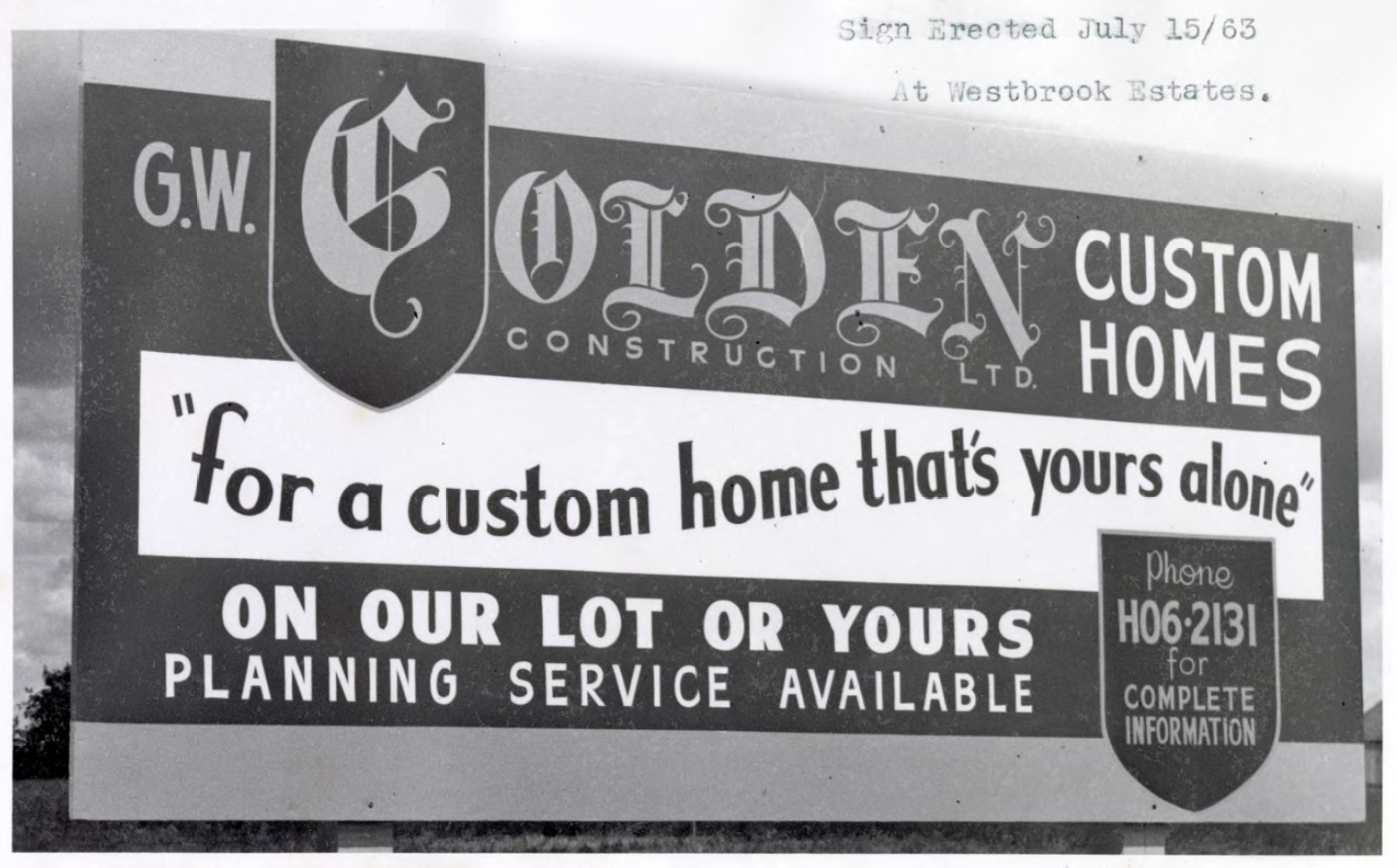 Photo of a billboard for Golden Homes. The billboard says: G.W. Golden Homes Construction Ltd. Custom Homes. For a custom home that's yours alone. On our lot or yours. Planning service available. Phone H06-2131 for complete information.