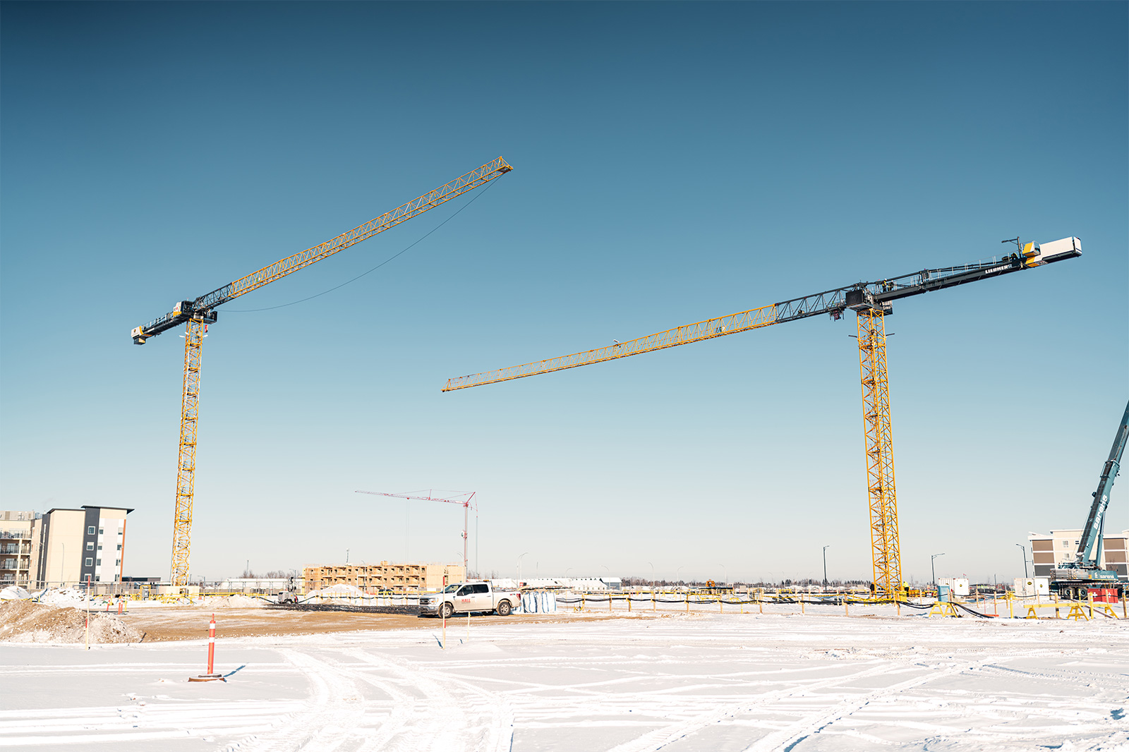Two construction cranes towering above the Lewis Farms Facility and Park Project (photo - PCL Construction). 