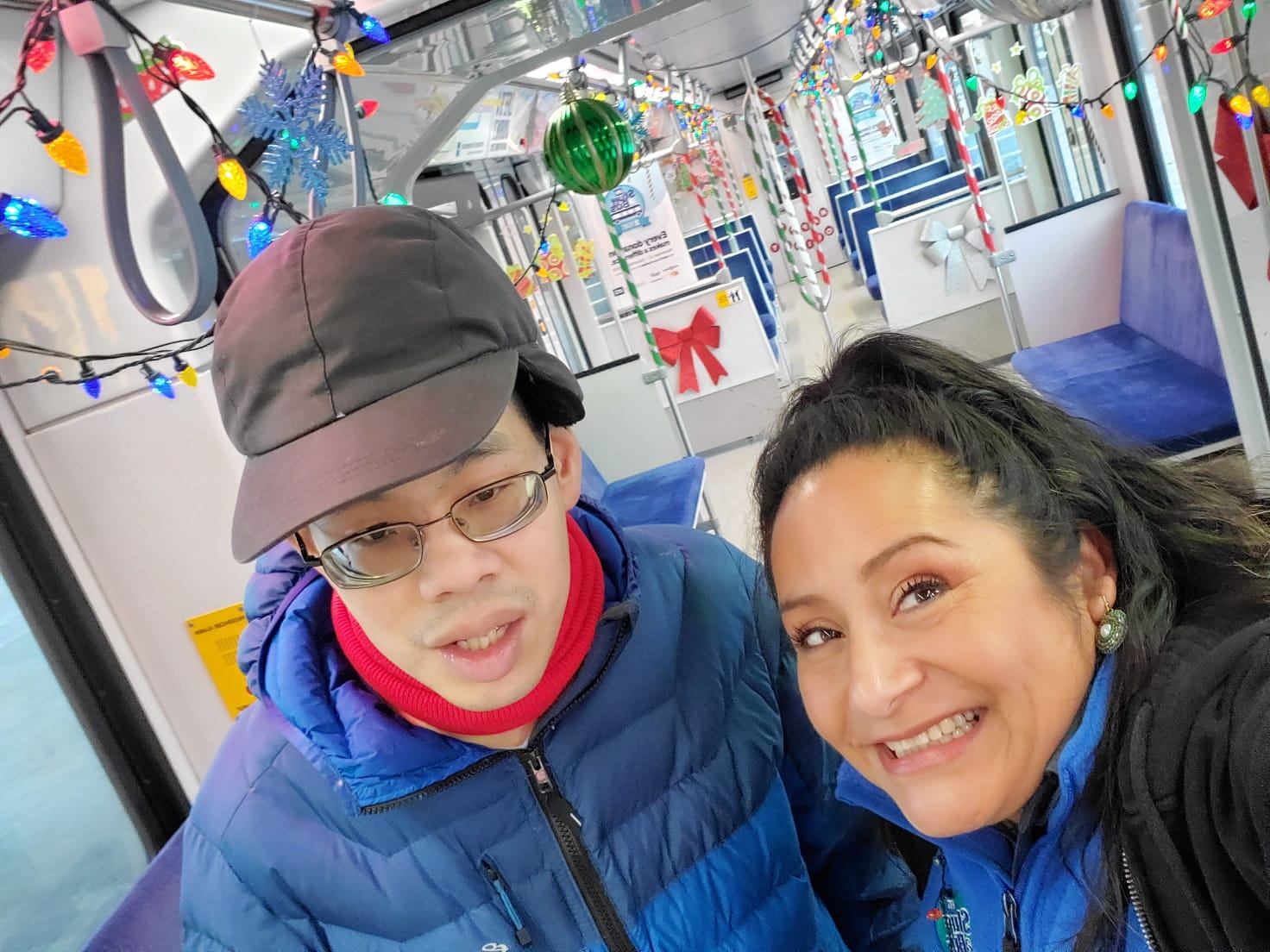 David Tsang and Reina Granados in a decorated LRT car for Stuff a Bus, November 2021.