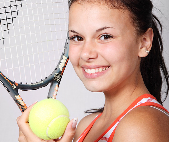 girl with tennis ball and racket