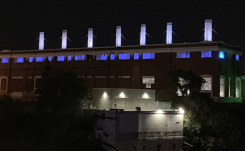 Rossdale power plant lit up at night.