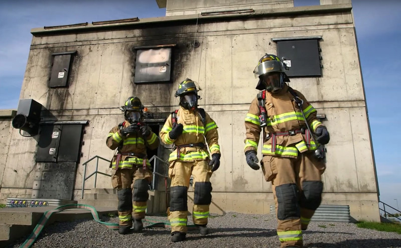 Group of 3 firefighters walking away from building