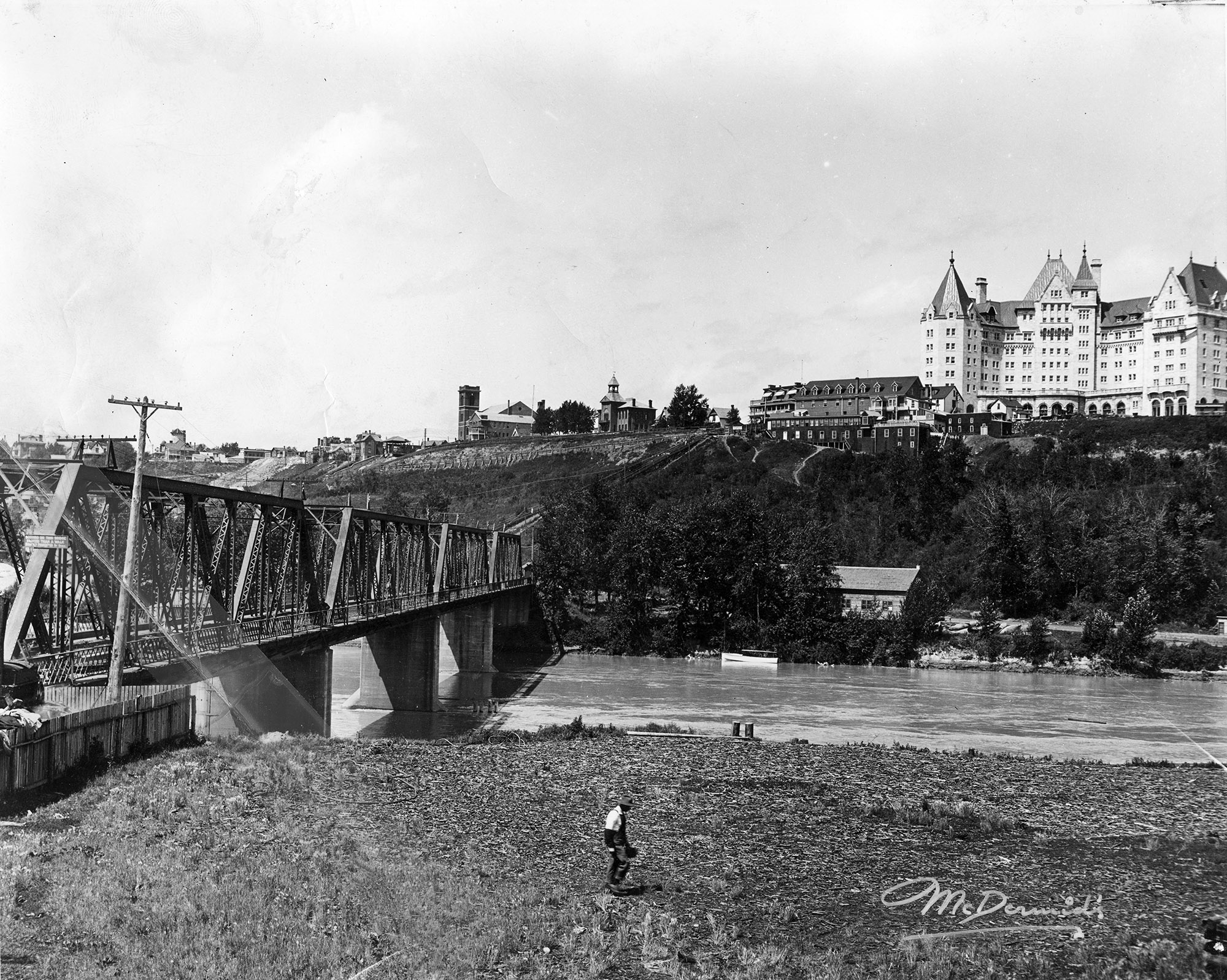 Black and white photo of Alberta Motor Boat Co. as seen from across the North Saskatchewan River