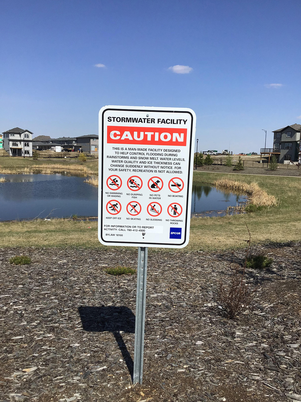 A sign at a stormwater facility at normal water level
