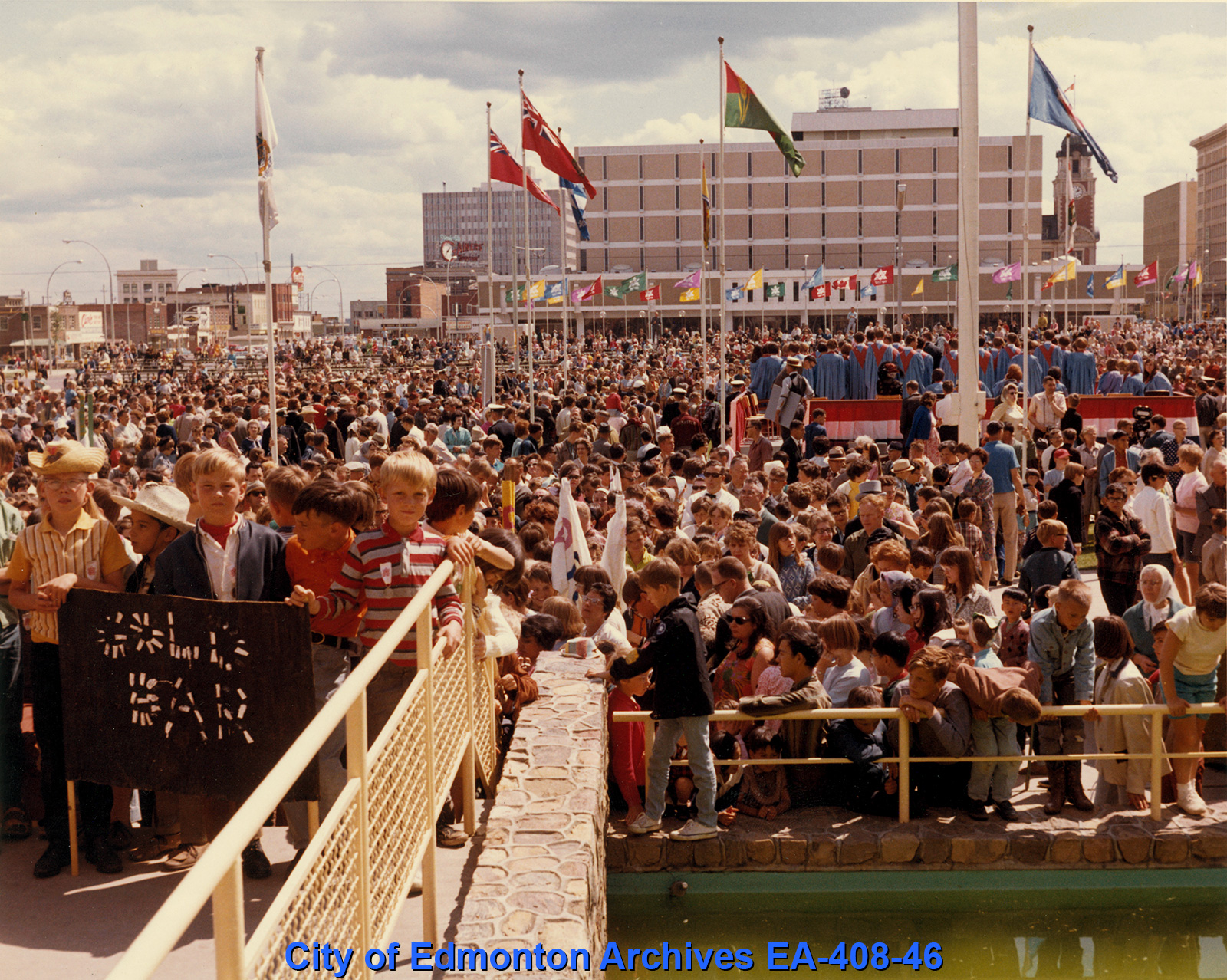 A photograph of a large crowd of people celebrating in front of Edmonton's City Hall.