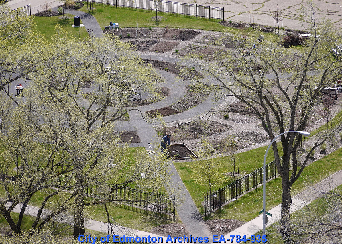 An aerial photo workers prepping a flower garden in early spring.