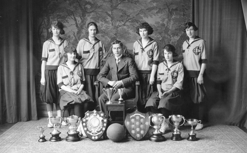 Black and white Edmonton Grads team photo, with awards.